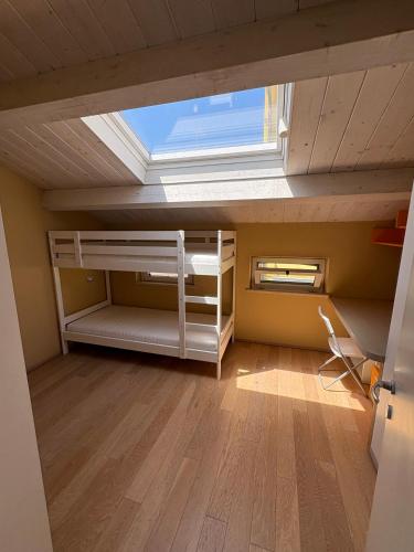 an attic room with a bed and a window at Dimora Dell Olmo in Civitanova Marche