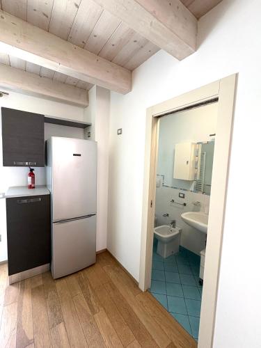 a kitchen with a refrigerator and a sink at Dimora Dell Olmo in Civitanova Marche