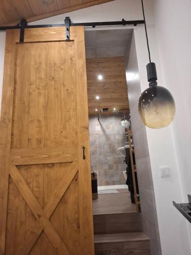 a sliding barn door in a bathroom with a shower at Casa do Chico in Mértola