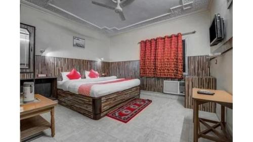 a bedroom with a large bed with red pillows at HOTEL Embassy in Rānchī