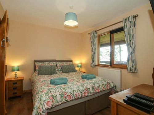 a bedroom with a bed with green pillows at Valley View Lodge in Trelystan