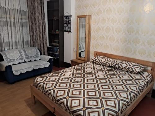 a bedroom with a large bed and a chair at Serene Lodge in Shillong