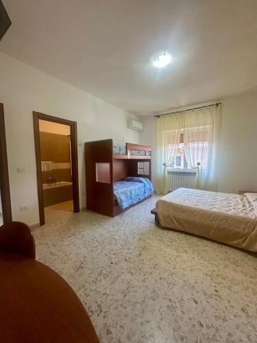 a bedroom with two beds and a window at Lincoln B&B in Caserta