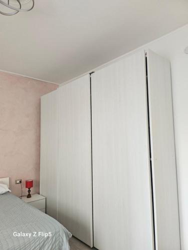a bedroom with white wardrobes at Fortuna in Diano Marina