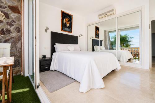 a bedroom with two beds and a large window at Villa Gisel in La Playa de Tauro