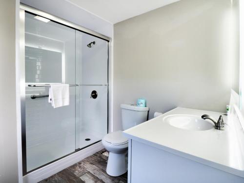 a bathroom with a shower and a toilet and a sink at Ogunquit Tides in Ogunquit