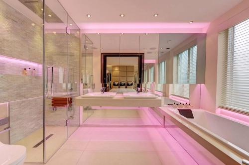a pink bathroom with two sinks and a large mirror at MariaHilferHome in Vienna