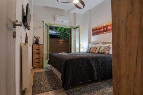 a bedroom with a bed and a door to a hallway at ZoYa`s Apartments in Agria