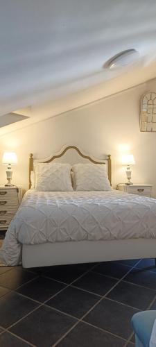 a bedroom with a large white bed with two lamps at ATTIC BAY - Cozy Stay with Sea View in Câmara de Lobos