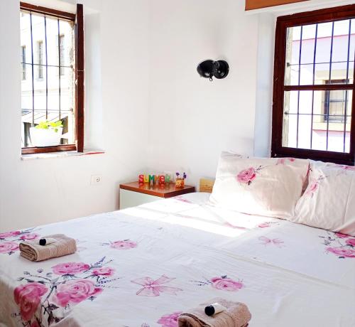 a bedroom with a bed with two towels on it at Rise And Shine Rooms Korca in Korçë