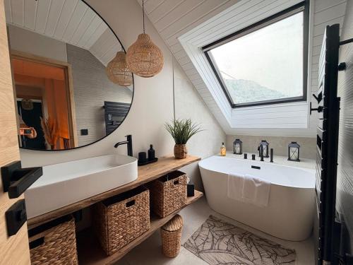 a bathroom with a large sink and a mirror at La Maison Du Lac in Doussard