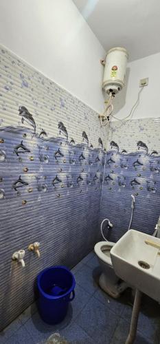 a bathroom with a toilet and a sink at JSM DELUXE Ac in Vellore