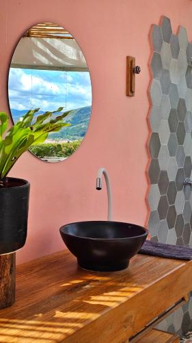 a bathroom with a black sink and a mirror at Amatea de Villa de Leyva in Villa de Leyva