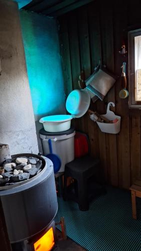 a small kitchen with a stove and a sink at B&B RhinoSauna in Vihti
