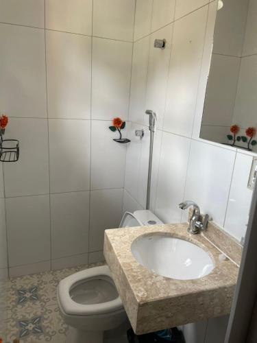 a bathroom with a sink and a toilet at Pousada Solar Central in Prados