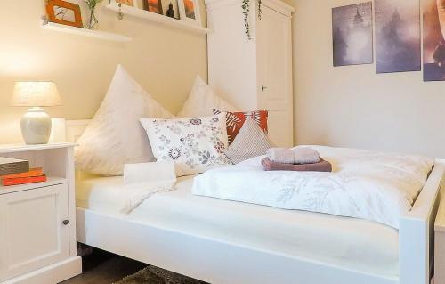 a white bed with pillows on it in a room at Friendly Home Doppel-Doppelappartement Union in Bornheim
