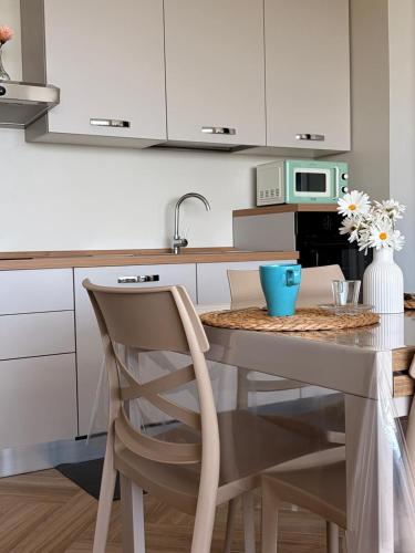 a kitchen with a table with a blue bowl on it at Circe Casa Vacanze in San Menaio