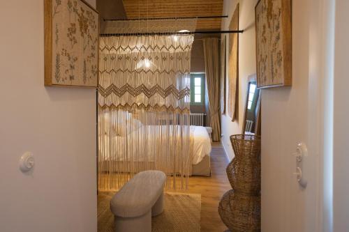 a room with a bedroom with a bed and a door at BaguHouse in Pombal