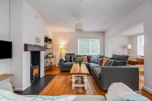 a living room with a couch and a fireplace at Saltwater, East Wittering in East Wittering