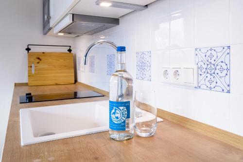 a bottle of water sitting on a counter next to two glasses at Zweitraum in Oldenburg in Oldenburg
