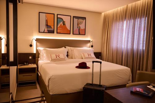 a hotel room with a bed with a hat on it at Royal Collection Paulista in São Paulo