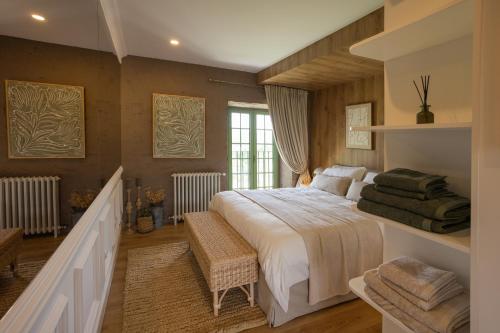 a bedroom with a large bed and a staircase at BaguHouse in Pombal