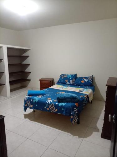 a bedroom with a bed with blue sheets on it at Ginebramagico in Ginebra