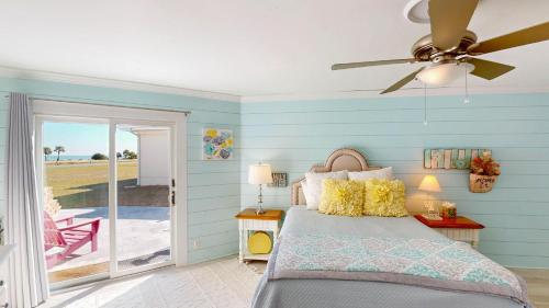 a bedroom with a bed and a ceiling fan at Lighthouse Unit B in Jekyll Island
