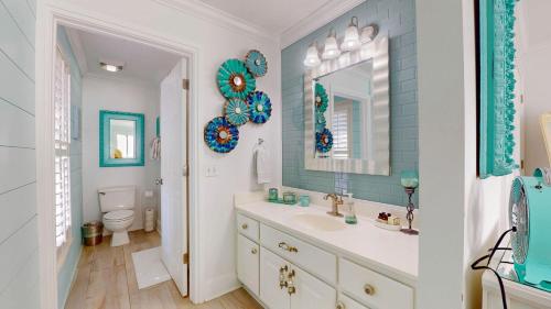a bathroom with a sink and a mirror and a toilet at Lighthouse Unit B in Jekyll Island
