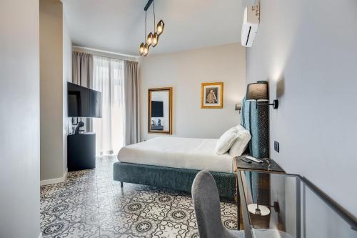 a hotel room with a bed and a balcony at Best Western Plus Fontana Falconieri Hotel in Messina