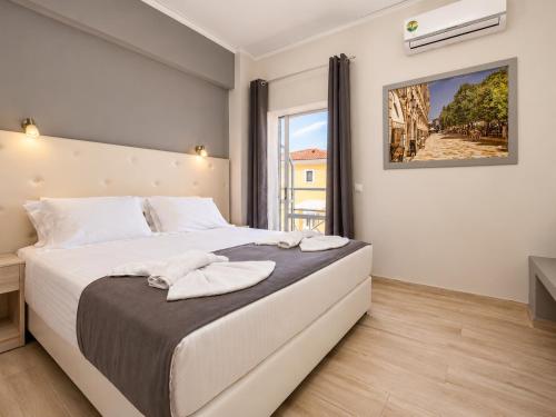 a bedroom with a large bed with towels on it at San Georgio Hotel in Agios Georgios Pagon