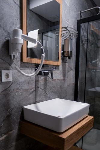 a bathroom with a white sink and a mirror at Canata Çeşme in Çeşme