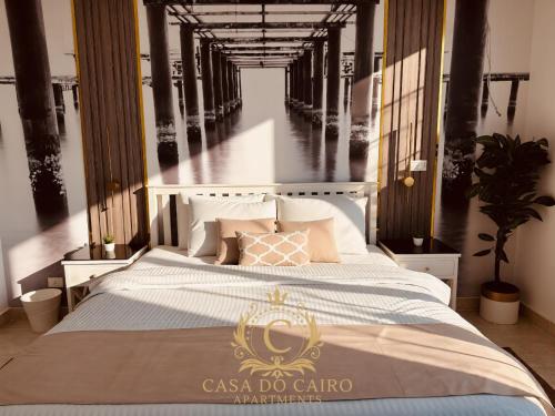 a room with a bed with a casa do calico sign on it at Casa Do Cairo - Rehab City in Cairo