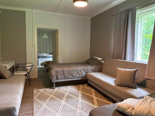 a living room with a couch and a table at Majoitus Eura in Kauttua