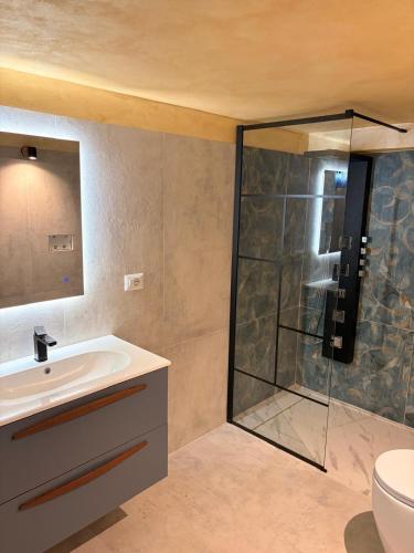 a bathroom with a sink and a shower at Casa Van Gogh Catania in Catania