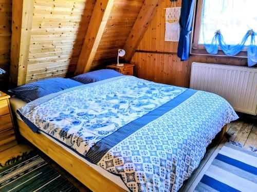a bedroom with a bed in a wooden cabin at Haus Paradiesecke in Waldbrunn
