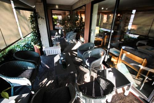 a group of chairs and tables in a restaurant at Hotel Canturio in Cantù