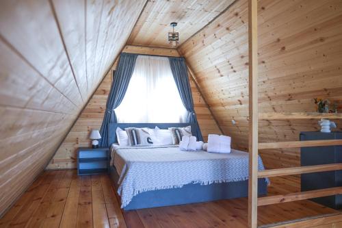 a bedroom with a bed in a log cabin at Gemini Cottage in Dusheti in Dushetʼi