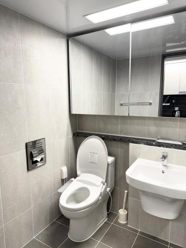 a bathroom with a toilet and a sink at Yangyang Surfing Beach 19 in Saetchak