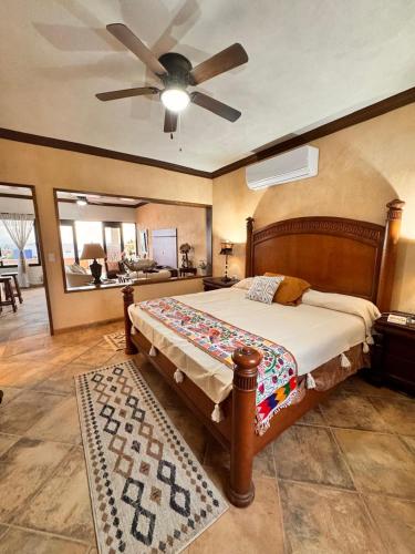 a bedroom with a bed with a ceiling fan at Casa San Jerónimo Departamentos in Todos Santos