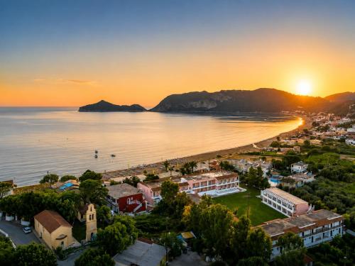 an aerial view of a city and a beach at sunset at San Georgio Hotel in Agios Georgios Pagon