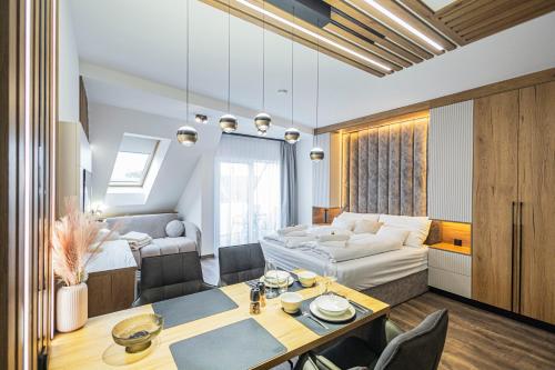 a living room with a table and a couch at ELYX Home Apartmanok in Sárvár