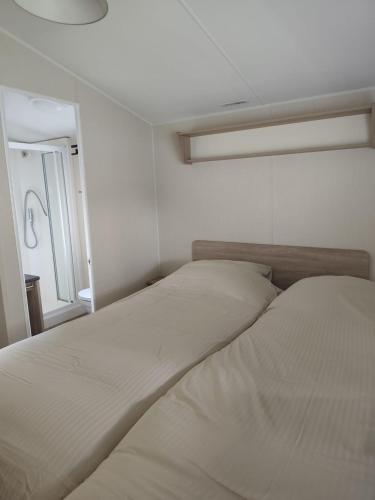a bedroom with two beds and a window at Wima Chalet in Sevenum