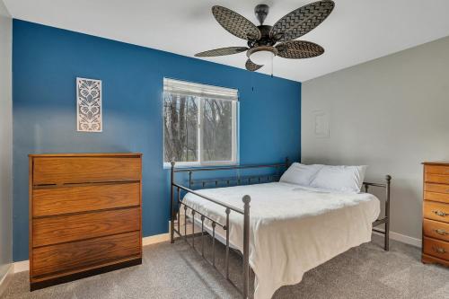 a blue bedroom with a bed and a ceiling fan at Luxury Mountain Villa - 3 bedroom, hot-tub, fire-pit in Hunter