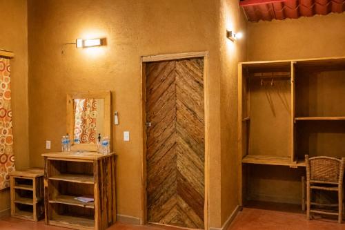 a room with a wooden door in a room at Ixak Cabañas in La Pimienta