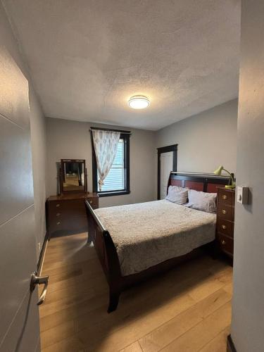 a bedroom with a bed and a window at Blue House in Halifax