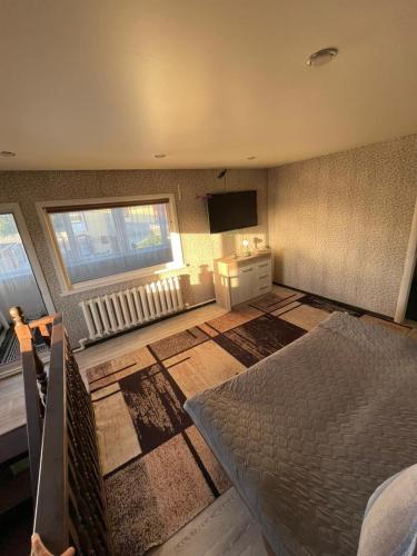 a bedroom with a bed and a television in it at Домики ШАХ in Borovoye
