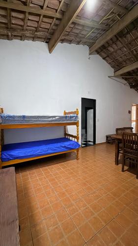 a large room with two bunk beds in it at Casa temporada Ilha Comprida 350m da praia in Ilha Comprida