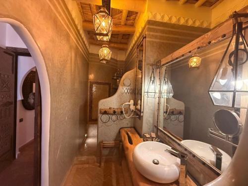 a bathroom with a sink and a mirror at Eden Boutique Hotel and Spa in Boumalne Dades