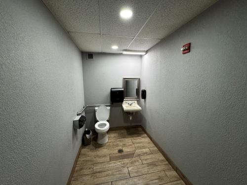 a bathroom with a toilet and a sink at Super 8 by Wyndham Conway in Conway